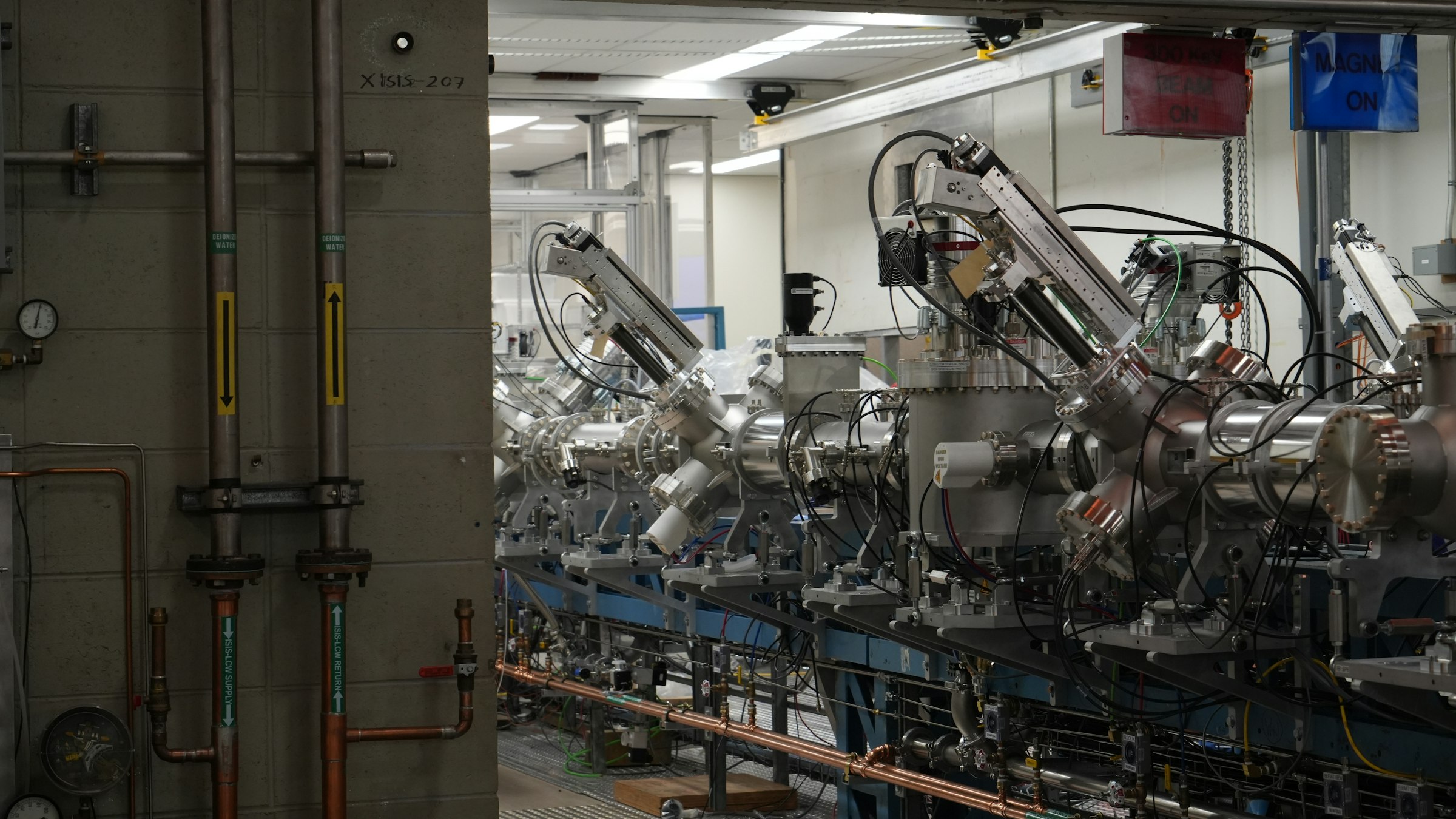 A long row of complex industrial machinery in a modern facility